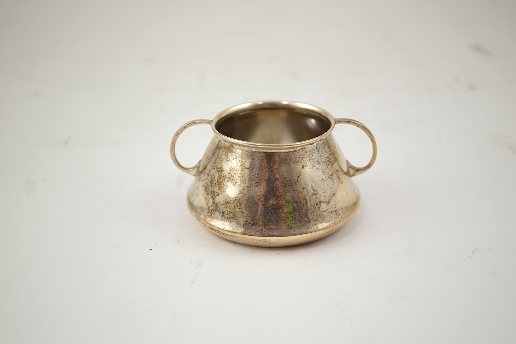 An Edwardian silver bachelor's two handled sugar bowl and matching sugar tongs, by Liberty & Co